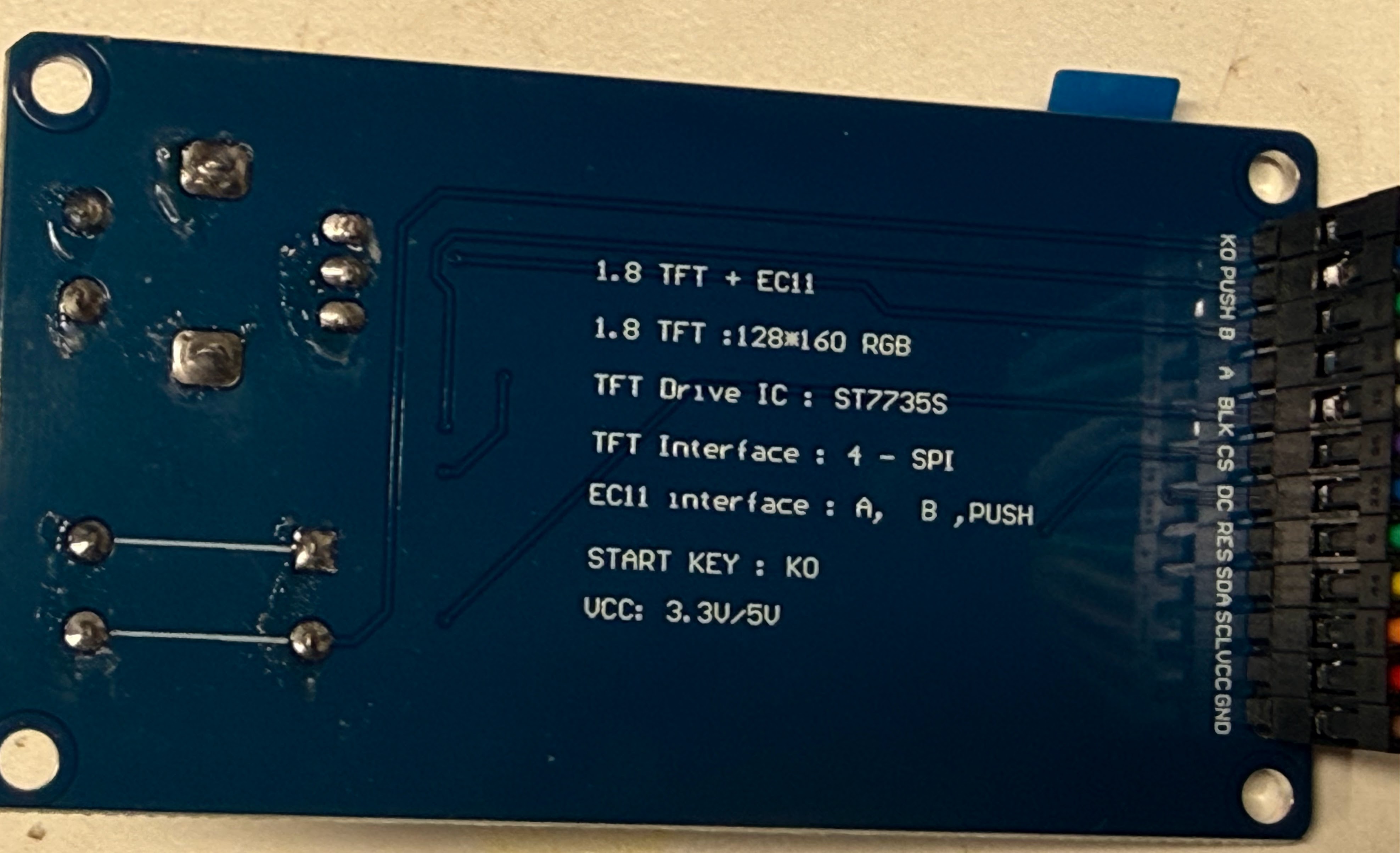 The back of the display board. White printing reads: 1.8 TFT + EC11, 128*160 RGB, TFT Drive IC ST7735S, TFT Interface 4-SPI, EC11 interface A, B, PUSH, START KEY K0, VCC 3.3V/5V