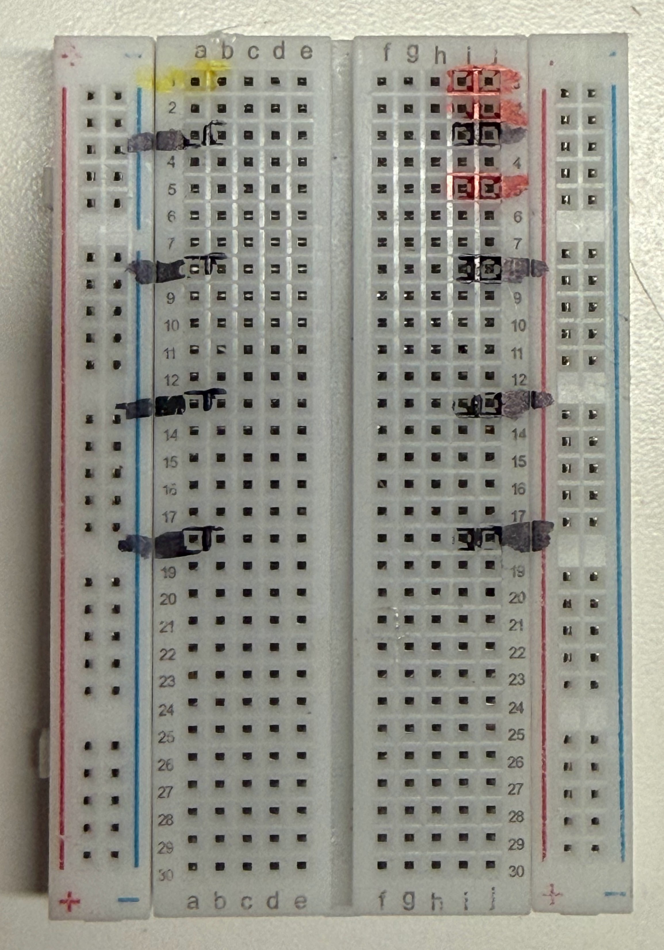 Breadboard with GND, power and data rails marked in permanent marker